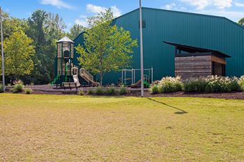 A playground in front of a green building
